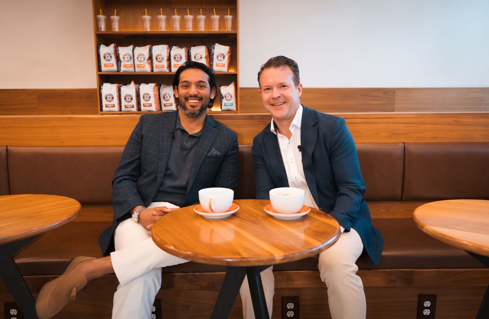 Dr. Nate Radcliffe with a guest beside the coffee bar