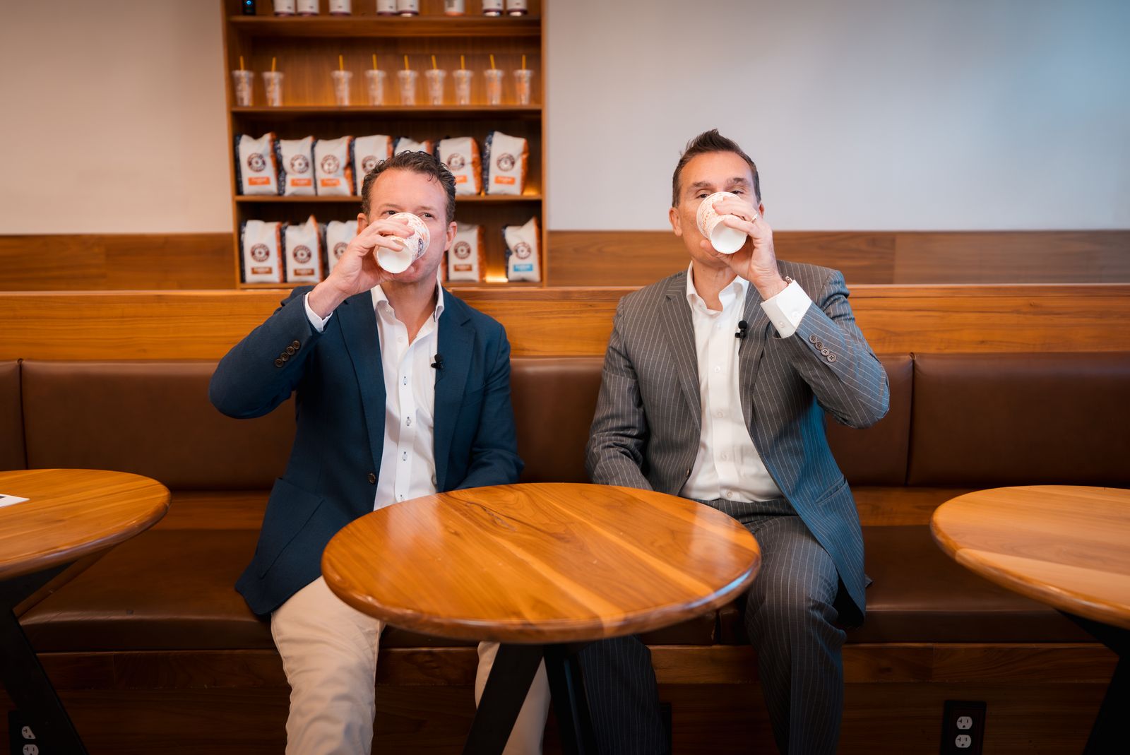 Host and guest sipping coffee mid-conversation