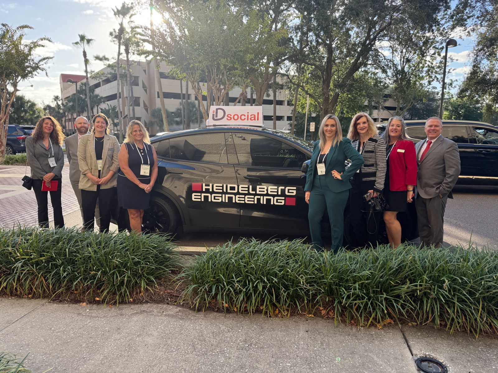 A group of eyecare leaders gathered around the iD Social EyeCab at a meeting